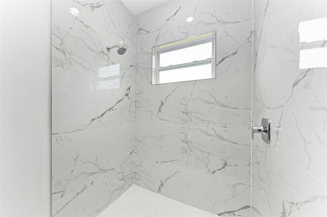 bathroom with tiled shower