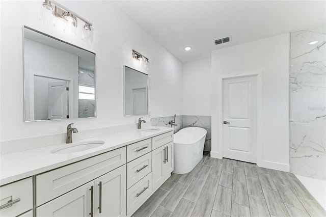 bathroom with plus walk in shower, vanity, and tile walls