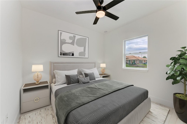 bedroom with ceiling fan and light hardwood / wood-style floors