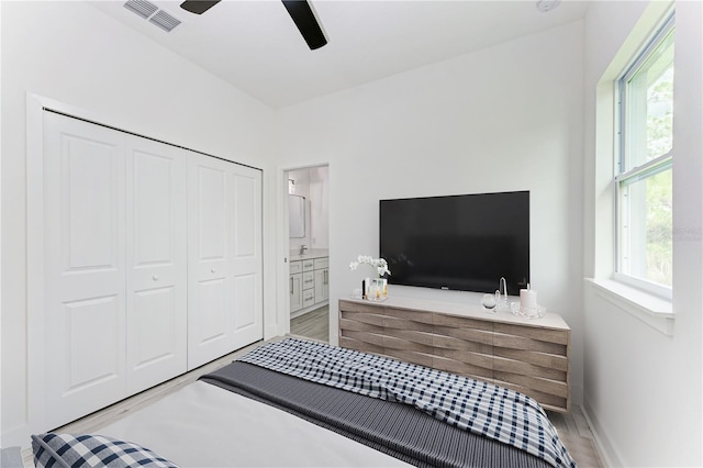 bedroom featuring connected bathroom, a closet, and ceiling fan