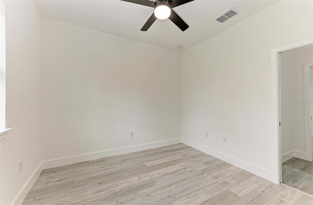 empty room featuring ceiling fan and light hardwood / wood-style floors