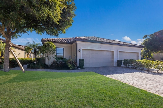 mediterranean / spanish house with a garage and a front yard