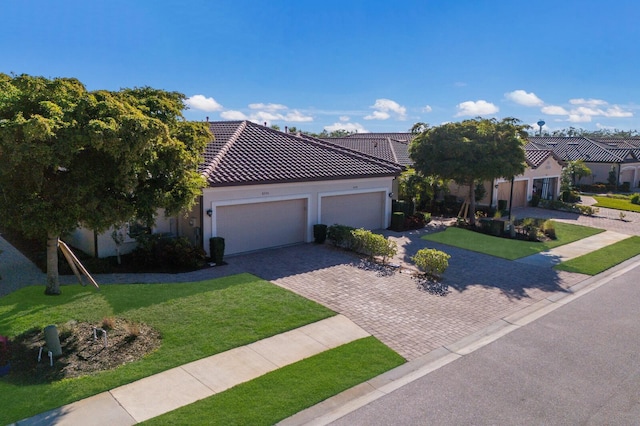 view of front of property featuring a garage and a front yard