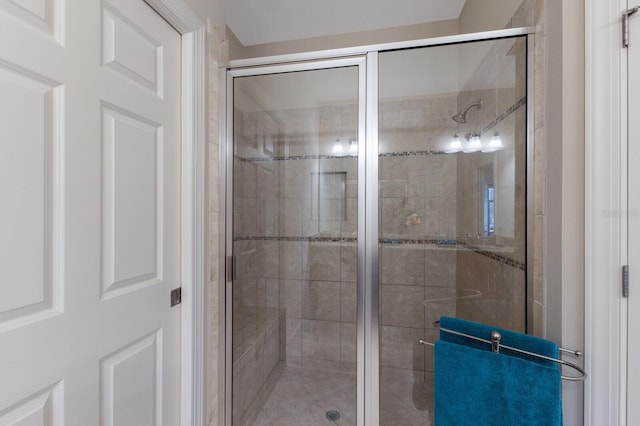 bathroom featuring a shower with shower door