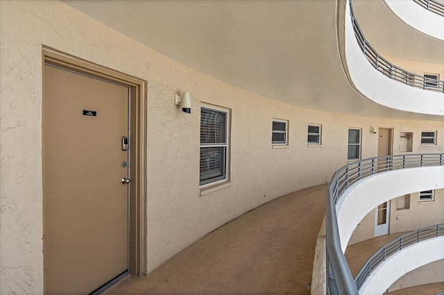 view of exterior entry featuring a balcony