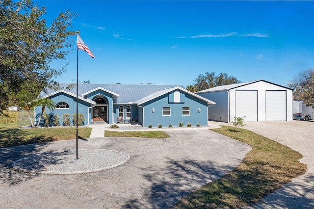 ranch-style home featuring an outbuilding and a garage