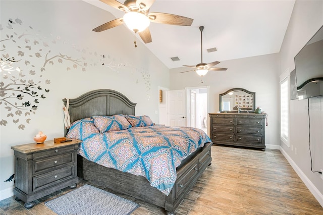 bedroom with light hardwood / wood-style floors, ceiling fan, and lofted ceiling