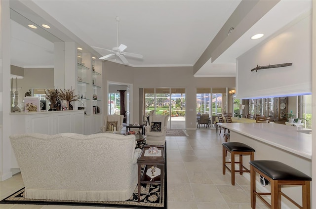 living room with ceiling fan and crown molding