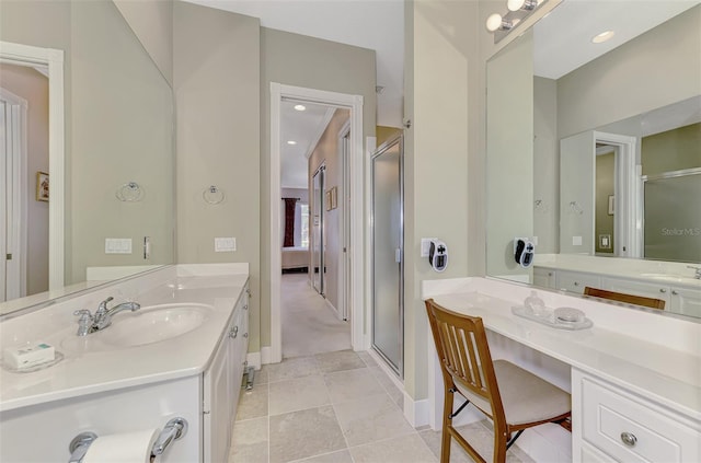 bathroom with tile patterned floors, vanity, and walk in shower