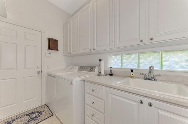 clothes washing area with tile patterned floors, cabinets, independent washer and dryer, and sink