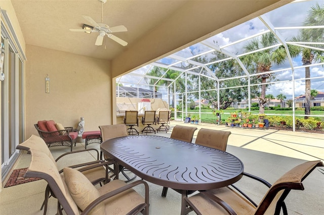 view of patio / terrace with ceiling fan and a lanai