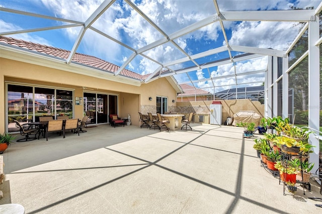 view of patio featuring a bar and a lanai