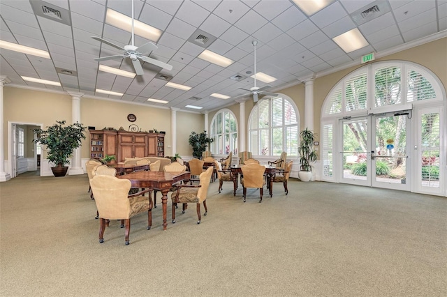 dining space featuring carpet, ceiling fan, a drop ceiling, and ornamental molding