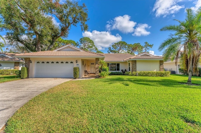 ranch-style house featuring a garage and a front lawn