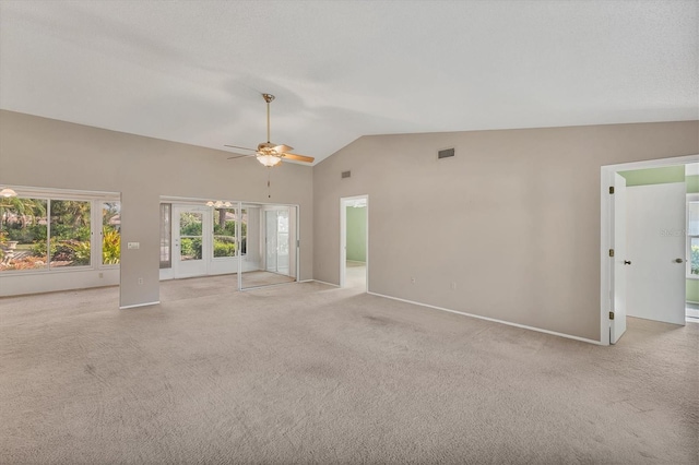 unfurnished living room featuring light colored carpet, vaulted ceiling, and ceiling fan