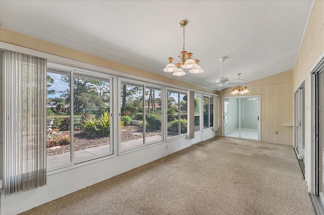 unfurnished sunroom featuring ceiling fan with notable chandelier and lofted ceiling