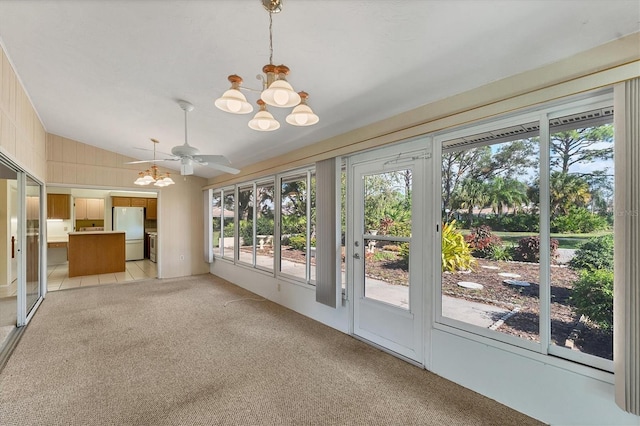 interior space with ceiling fan with notable chandelier and lofted ceiling