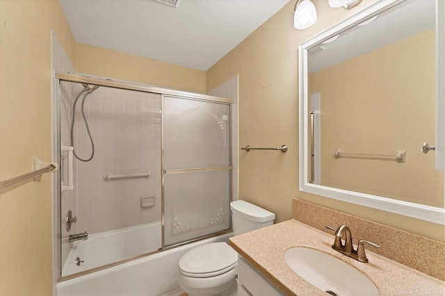 full bathroom with vanity, toilet, and bath / shower combo with glass door