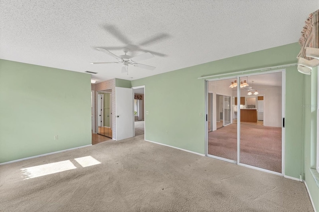 unfurnished bedroom featuring carpet flooring, ceiling fan, and a textured ceiling