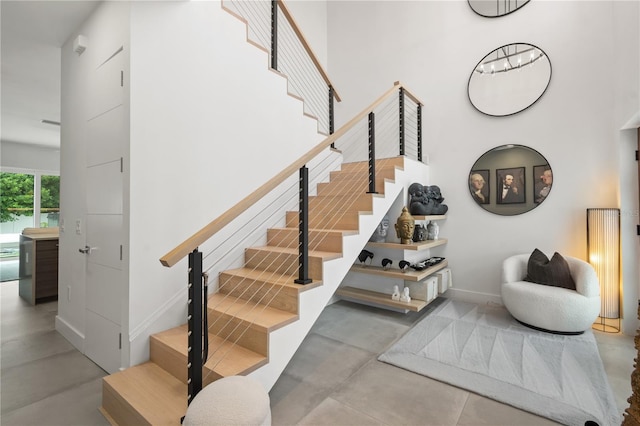 staircase featuring concrete flooring