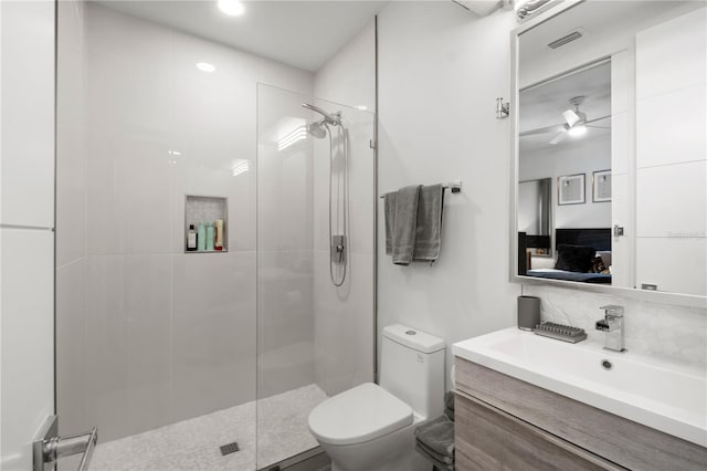 bathroom with vanity, ceiling fan, toilet, walk in shower, and tasteful backsplash