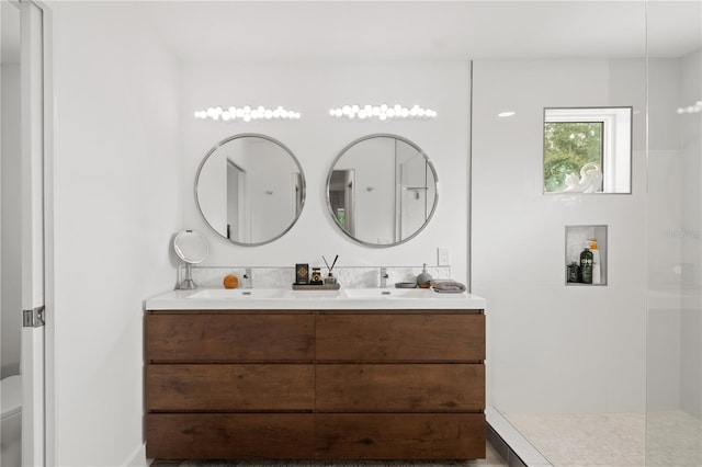 bathroom featuring a shower, vanity, and toilet