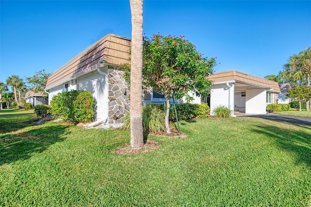 view of side of property with a lawn