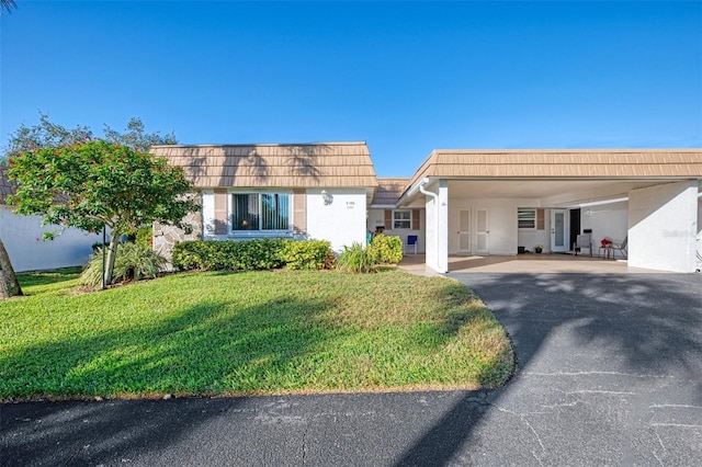 ranch-style house with a carport and a front lawn