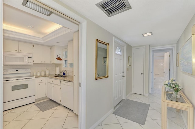 kitchen with white appliances, backsplash, sink, light tile patterned flooring, and light stone counters