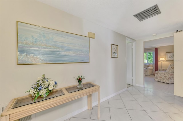 hall featuring light tile patterned flooring