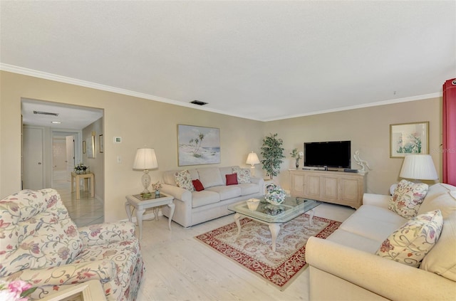 living room featuring light hardwood / wood-style flooring and ornamental molding