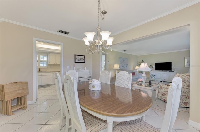 dining room featuring an inviting chandelier, crown molding, and light tile patterned flooring