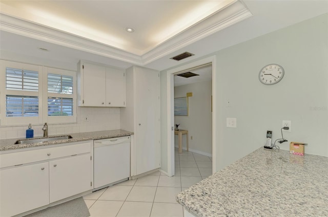 kitchen featuring white dishwasher, a raised ceiling, white cabinets, and sink