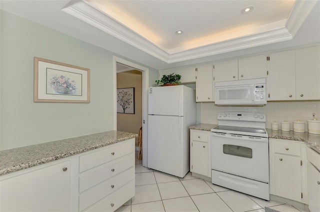 kitchen featuring white appliances, a tray ceiling, white cabinetry, and tasteful backsplash