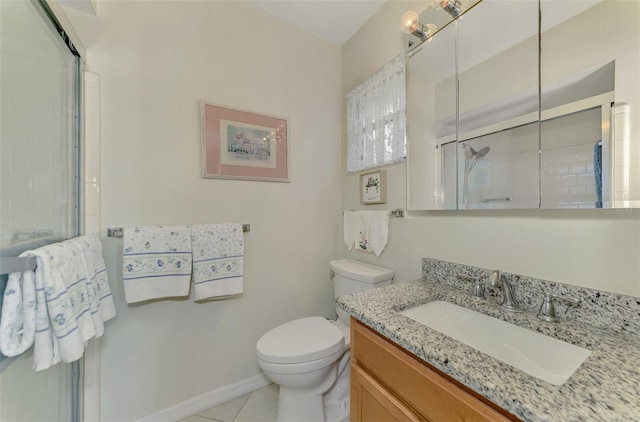 bathroom with tile patterned floors, vanity, toilet, and a shower with shower door