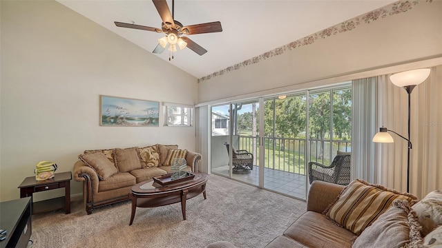 carpeted living room with ceiling fan and high vaulted ceiling