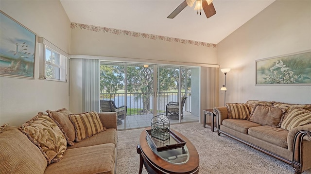 carpeted living room featuring vaulted ceiling and ceiling fan