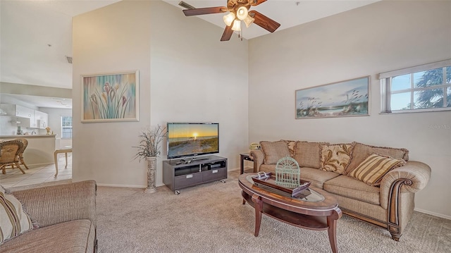 living room featuring ceiling fan, a healthy amount of sunlight, light colored carpet, and lofted ceiling