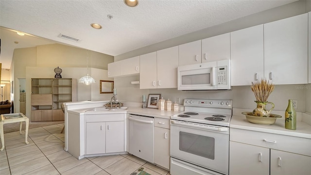 kitchen with white appliances, white cabinets, hanging light fixtures, light tile patterned floors, and kitchen peninsula