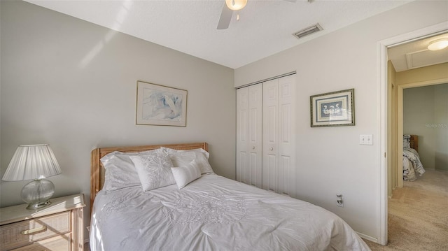 bedroom with carpet flooring, ceiling fan, and a closet