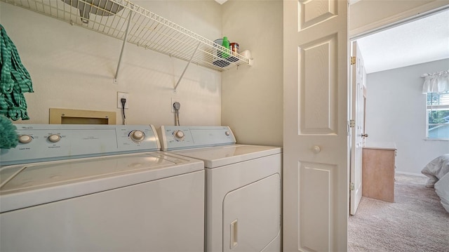 washroom with separate washer and dryer and carpet floors