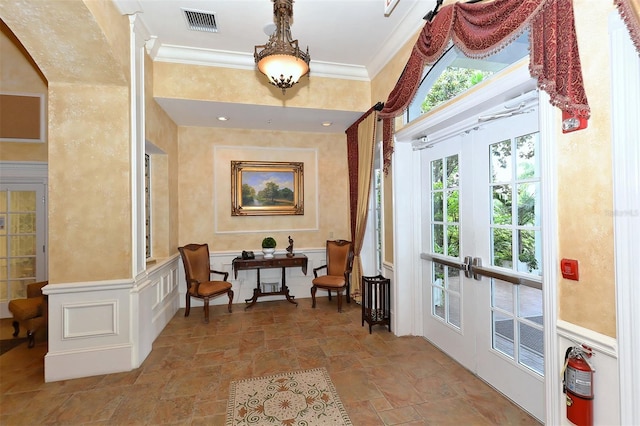 interior space featuring french doors and crown molding