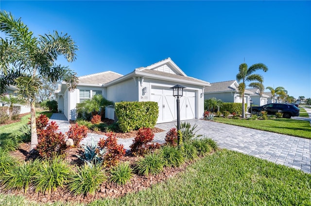 view of front of home featuring a garage and a front lawn