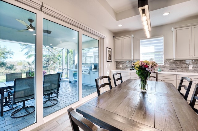 dining area with light hardwood / wood-style flooring and ceiling fan