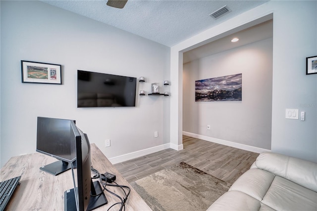 office space with ceiling fan and a textured ceiling