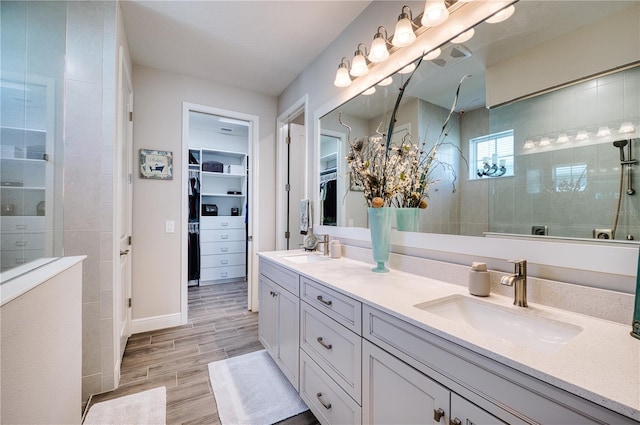 bathroom with vanity and tiled shower