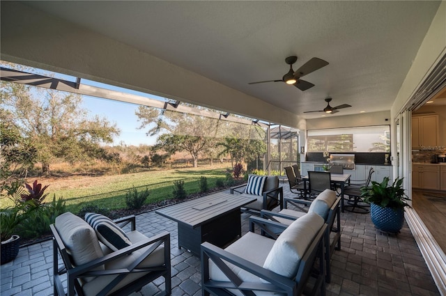 view of patio with an outdoor hangout area, area for grilling, ceiling fan, and grilling area