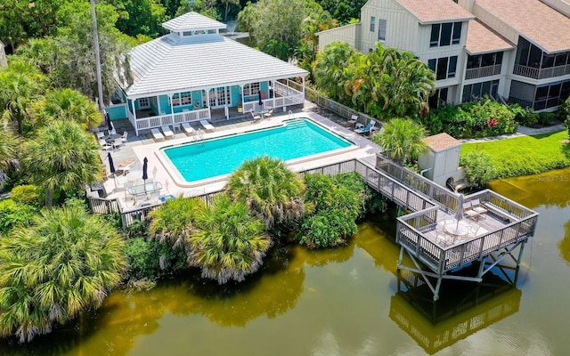 view of pool featuring a patio and a water view