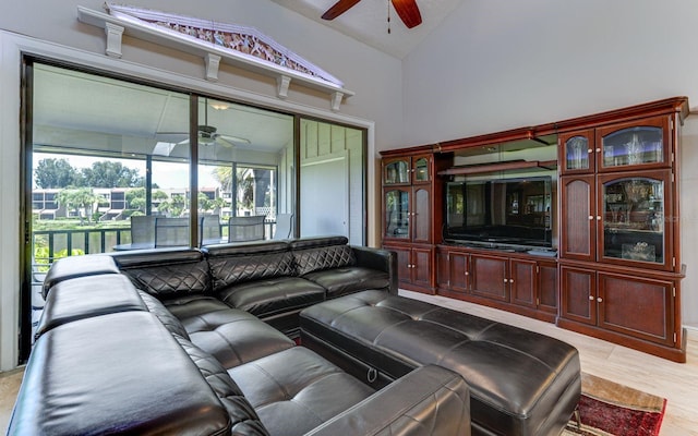 living room featuring light hardwood / wood-style floors, ceiling fan, and lofted ceiling