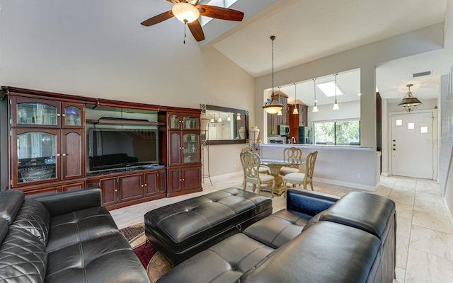 living room with ceiling fan and high vaulted ceiling